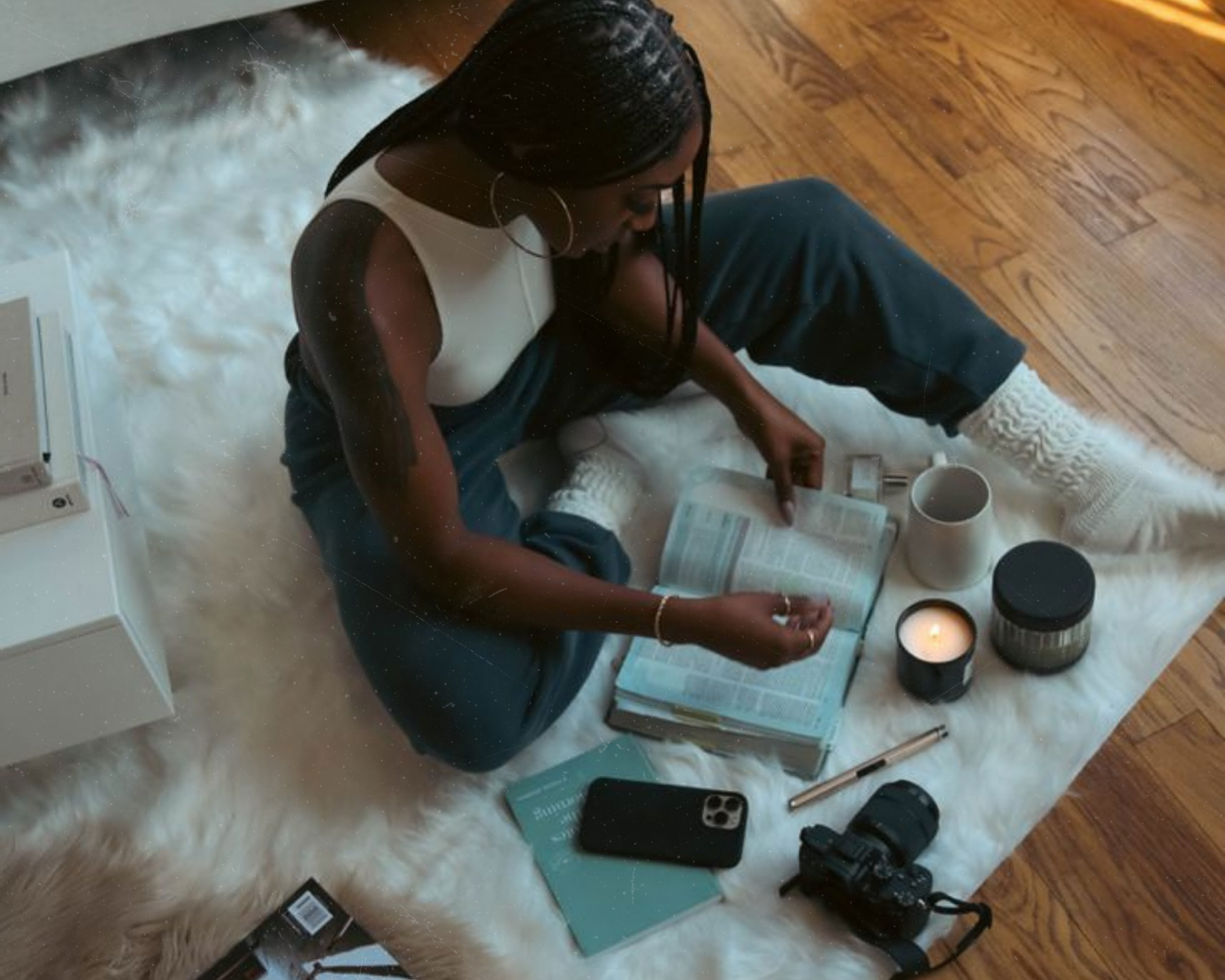 black woman at home doing research on fragrance Black IV collection by Arm's Reach Black-owned perfume brand